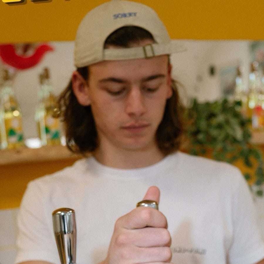 Elliot, casquette sur la tête, sert une bière à la tireuse du Rond-Point